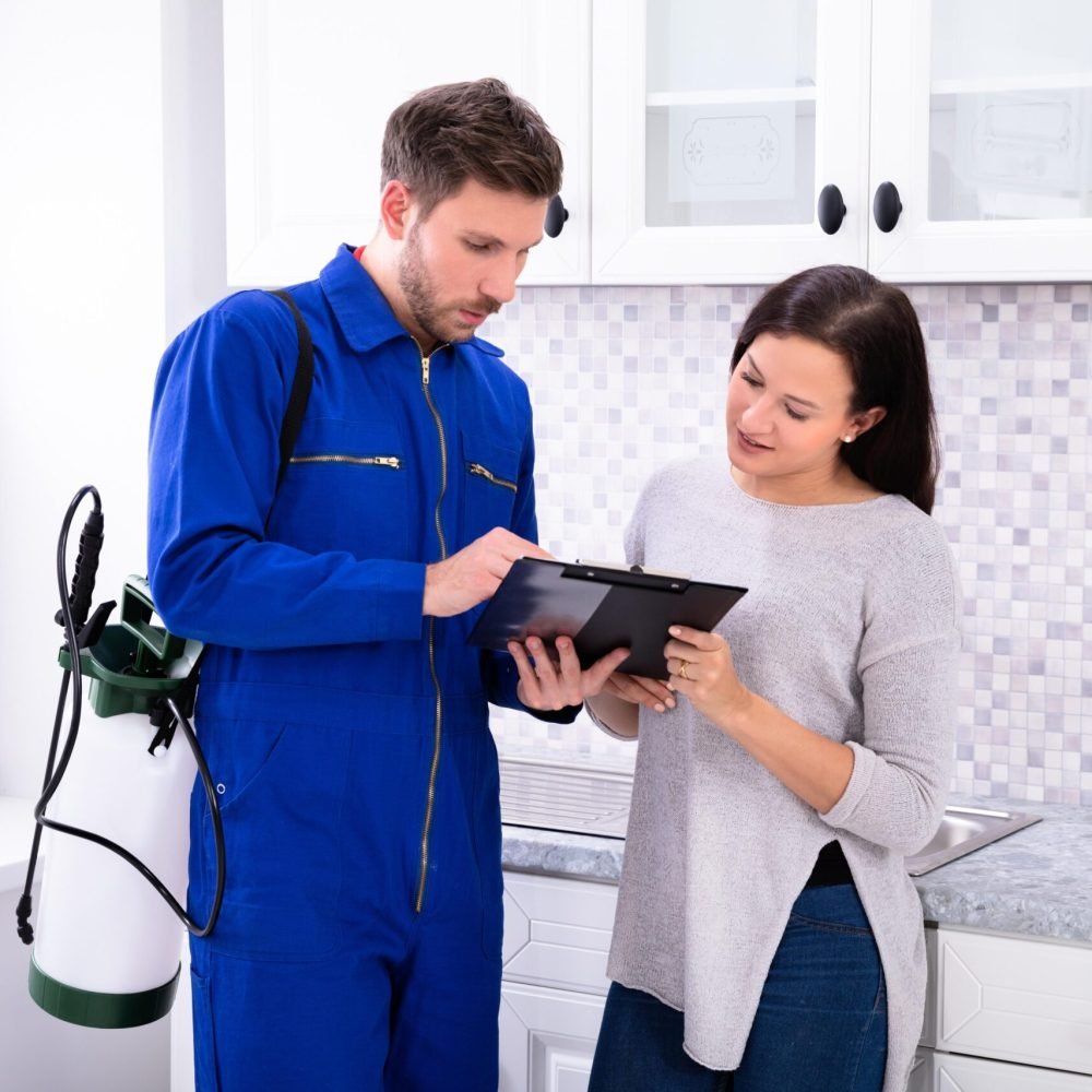 Pest Control Worker Showing Invoice To Woman